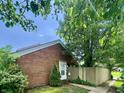 Charming single-Gathering home with brick facade and well-maintained front yard with mature trees at 7392 S Meridian St, Indianapolis, IN 46217