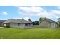 Spacious backyard with a white picket fence and shed, perfect for outdoor activities and relaxation at 8028 Meadow Bend Ln, Indianapolis, IN 46259