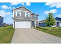Inviting two-story home features a two-car garage, classic siding, and a well-manicured lawn and landscaping at 851 Sonoma Ln, Greenfield, IN 46140