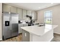 Bright kitchen features stainless steel appliances, light gray cabinets, and a center island with a sink at 851 Sonoma Ln, Greenfield, IN 46140
