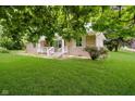Inviting single-story home showcasing a lush, green lawn, classic facade, and charming front yard at 91 N Raceway Rd, Indianapolis, IN 46234