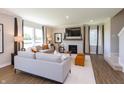 Bright living room featuring neutral tones, a fireplace, large windows, and comfortable seating arrangements at 921 Shadow Dr, Danville, IN 46122