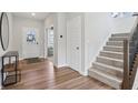 Bright foyer features wood floors, a staircase, and access to the living areas at 9671 Ridgecrest Ln, McCordsville, IN 46055