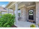 Charming front porch features brick accents, a welcoming wreath, and a cozy welcome mat at 9671 Ridgecrest Ln, McCordsville, IN 46055