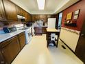 Functional kitchen with laminate countertops, white appliances, and a center island, offering ample workspace at 1008 Whispering Trl, Greenfield, IN 46140
