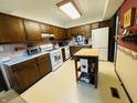 Functional kitchen with laminate countertops, white appliances, and a center island, offering ample workspace at 1008 Whispering Trl, Greenfield, IN 46140