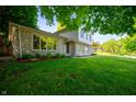 Landscaped front yard showcasing a stone facade and large picture window at 1031 Lancashire Ln, Pendleton, IN 46064