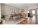 Elegant dining room featuring stylish furniture, hardwood floors, and a decorative wall clock at 11138 Bear Hollow Dr, Indianapolis, IN 46229