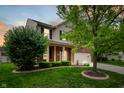 Lovely two-story home with a well manicured lawn, landscaping, and attached two car garage at 11138 Bear Hollow Dr, Indianapolis, IN 46229