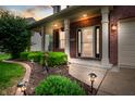 Inviting front porch with white pillars, brick accents, and decorative landscaping with solar lights at 11138 Bear Hollow Dr, Indianapolis, IN 46229