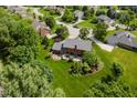 A sprawling green lawn and backyard with a brick patio are seen from above at 11354 Royal Pl, Carmel, IN 46032