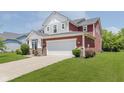 Well-maintained two-story home featuring a two-car garage, manicured lawn, and attractive exterior details at 11840 Crossbill Ct, Noblesville, IN 46060