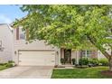 Delightful home featuring a well-manicured lawn, a two-car garage and a charming front entrance at 12259 Sweet Creek Trl, Fishers, IN 46037