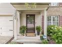 Close-up of the front porch showcasing stylish potted plants, a wreath, and the house number at 12259 Sweet Creek Trl, Fishers, IN 46037