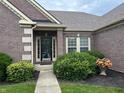 Attractive entryway with meticulously maintained garden beds and walkway at 13744 Fieldshire Ter, Carmel, IN 46074