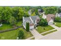 Aerial view of a lovely home with a spacious yard and mature trees in a desirable neighborhood at 14492 Cotswold Ln, Carmel, IN 46033