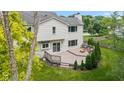 View of backyard deck with seating, surrounded by lush landscaping creating a perfect outdoor space at 14492 Cotswold Ln, Carmel, IN 46033