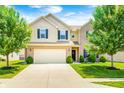 Inviting two-story home boasts a manicured lawn, brick accents, and an attached two-car garage at 15178 Silver Charm Dr, Noblesville, IN 46060