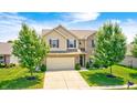 A well-maintained home with a two-car garage, lush green lawn, and mature trees, reflecting suburban charm at 15178 Silver Charm Dr, Noblesville, IN 46060