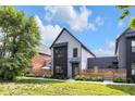 Stylish two-story home featuring gray siding, dark accents, and a fenced-in yard with fresh landscaping at 1834 Rosette Way, Indianapolis, IN 46202