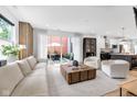 Bright living room with modern furniture, access to patio, and adjacent kitchen with island at 1834 Rosette Way, Indianapolis, IN 46202