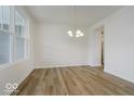 Open dining room features hardwood floors, white walls, and a chandelier at 18955 Seaforth Way, Westfield, IN 46074