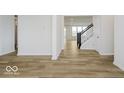 Open hallway features hardwood floors leading to the stairs at 18955 Seaforth Way, Westfield, IN 46074