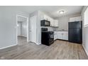 Efficient kitchen with black appliances, white cabinets, hardwood floors, and an open layout at 1931 Brentwood Dr, Anderson, IN 46011