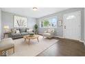 Bright living room featuring hardwood floors, a large window and stylish neutral decor at 1931 Brentwood Dr, Anderson, IN 46011