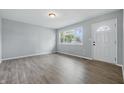 Inviting living room with hardwood floors, a front door, and a large window for plenty of natural light at 1931 Brentwood Dr, Anderson, IN 46011