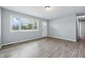Bright living room featuring hardwood floors and a large window with views of the neighborhood at 1931 Brentwood Dr, Anderson, IN 46011