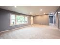 Bright living room with fresh carpet, a large window, and newly painted walls at 196 Park Ave, Bargersville, IN 46106