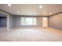 Spacious living room with plush carpeting, a bright window and modern recessed lighting at 196 Park Ave, Bargersville, IN 46106