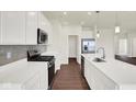 Bright kitchen with stainless steel appliances, white cabinets, and a sleek island with a modern faucet at 2021 Frost Line Ln, Greenfield, IN 93927