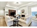 Comfortable living room featuring hardwood floors, a fireplace, and an entertainment center at 2612 Ruffian Dr, Westfield, IN 46074