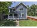 Attractive two-story home with a welcoming front porch and well-maintained lawn and landscaping at 2860 Winthrop Ave, Indianapolis, IN 46205