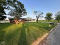 Attractive single-story home with a sprawling front lawn and mature trees at 2951 S Elizabeth St, Indianapolis, IN 46203