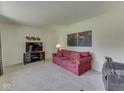 Comfortable living room featuring neutral carpet, cozy seating, and stylish decor at 343 E Waterbury Rd, Indianapolis, IN 46227
