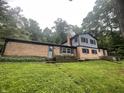 Split-level home with brick and siding exterior, complete with a backyard and surrounded by trees on a generous lot at 3545 Whippoorwill Lake N Dr, Monrovia, IN 46157