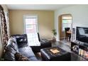 Warm living area with a leather sofa, accent pillows, modern flooring and connecting dining area at 3616 N Dearborn St, Indianapolis, IN 46218