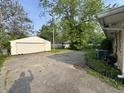 View of the property's garage and an AC unit attached to the side of the home at 3845 N Irvington Ave, Indianapolis, IN 46226