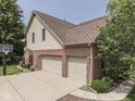 Spacious three-car garage on a brick and siding home with basketball hoop and mature landscaping at 4084 Mountbatton Dr, Greenwood, IN 46143