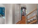 Bright hallway with wood floors, leading to a visible kitchen and additional living spaces at 4155 Rolling Trails Rd, Greenwood, IN 46142