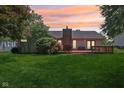 Expansive backyard showcasing a well-maintained lawn and a cozy brick fireplace feature at 430 Oakbrook Dr, Columbus, IN 47201