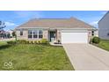 Charming brick home with a well-manicured lawn and attached two car garage at 4420 Wild Turkey Dr, Indianapolis, IN 46239