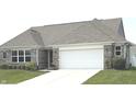 Charming brick home featuring a two-car garage and a well-maintained lawn, offering great curb appeal at 4420 Wild Turkey Dr, Indianapolis, IN 46239