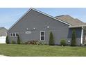 Well-manicured side yard with lush lawn, clean siding, and updated trim at 4420 Wild Turkey Dr, Indianapolis, IN 46239