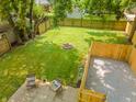 Expansive backyard features a large lawn, firepit, and patio area for outdoor enjoyment at 5636 Crittenden Ave, Indianapolis, IN 46220