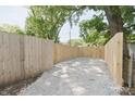 Gravel area with new wooden fence, ideal for parking or outdoor projects at 5636 Crittenden Ave, Indianapolis, IN 46220
