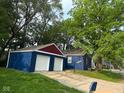 Exterior view featuring a detached garage matching the house's aesthetic at 5704 N Keystone Ave, Indianapolis, IN 46220
